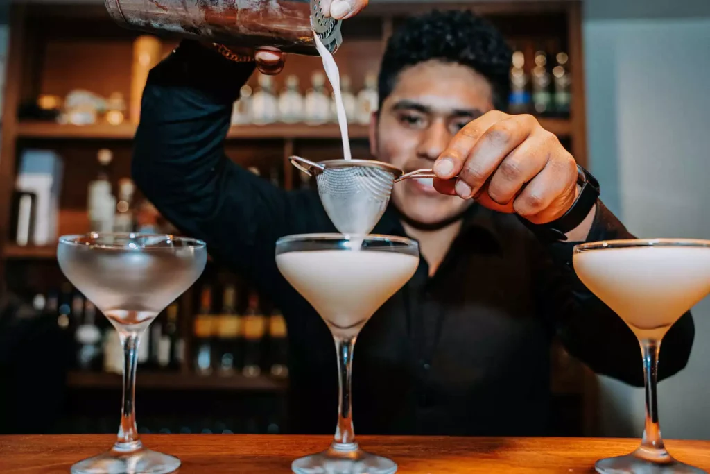 Bartender preparing pisco cocktails at the Moray bar, Cusco