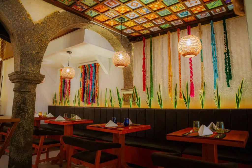 Colonial arch and Andean textiles in the dining room of Moray, Cusco historic center