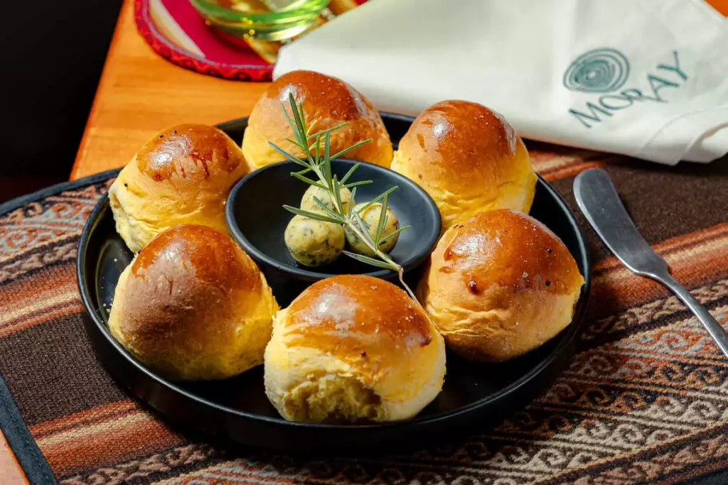 House bread rolls with herb butter at Moray restaurant, Cusco