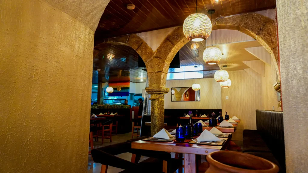Dining room with colonial arches and lanterns at Moray, Cusco